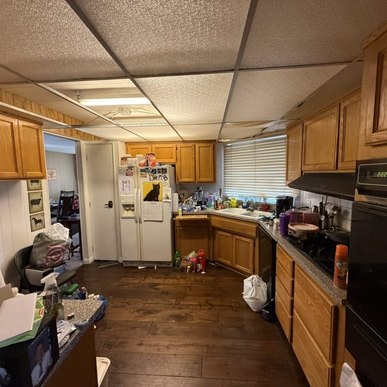 Kitchen interior of an older manufactured home that may need updates or repairs.