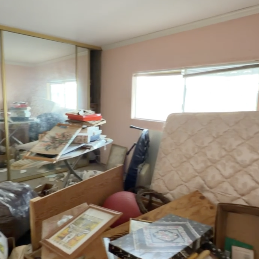Cluttered interior of a manufactured home that may have been left by tenants or is vacant.